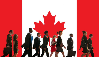 International workers walking in front of the Canadian flag