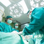Surgeons operating on patient