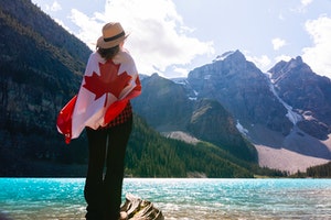 woman overlooking mountain with canadian flag