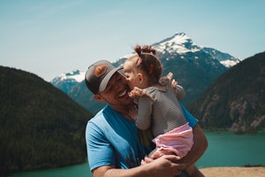 toddler kissing father on cheek