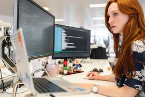 IT woman working at desk.