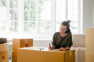 Woman packing boxes for her move to Canada