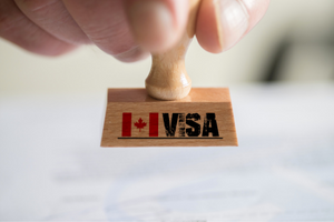 Person holding a Canada visa stamp